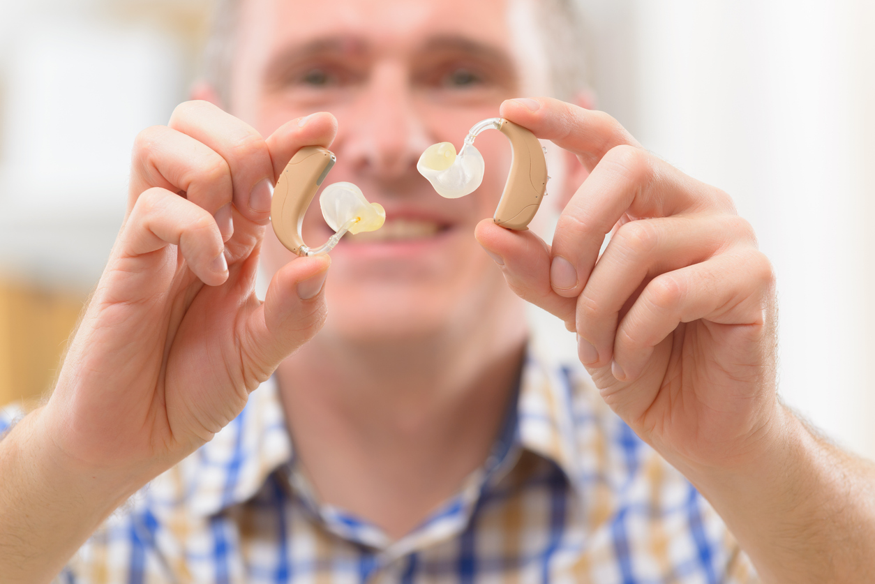 Man showing off his new hearing aids
